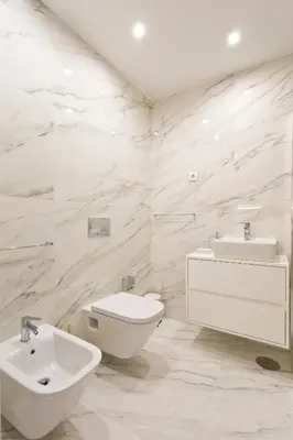 a white bathroom with a toilet and a sink at BOUTIQUE Rentals-THE ALMA Apt w/ balcony in Porto