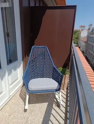 a blue chair sitting on a balcony at BOUTIQUE Rentals-THE ALMA Apt w/ balcony in Porto