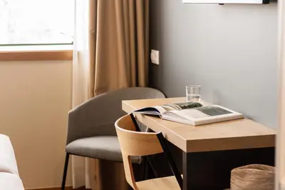 a bed with white sheets and pillows in a bedroom at room Select Porto in Porto