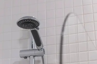 a shower head and its shadow in a bathroom at Loulé 246 · 1 bedroom apartment · Parking in Porto