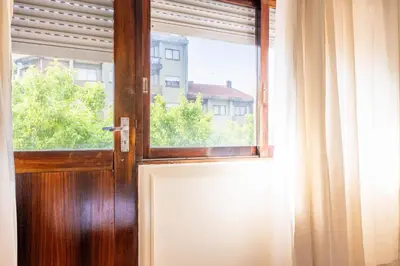 a wooden door with a window in a room at Convenient 3-Bedroom Apartments next to Bom Sucesso in Porto