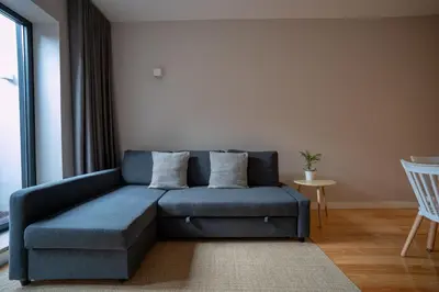 a blue couch sitting in a living room at Oporto Trendy Formosa in Porto