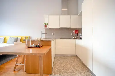 a kitchen and living room with a table and a couch at Oporto Trendy Formosa in Porto