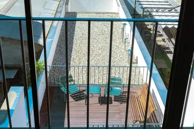 a balcony with chairs and a swimming pool at Oporto Trendy Formosa in Porto