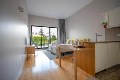 a kitchen and living room with a table and a couch at Oporto Trendy Formosa in Porto