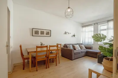 a living room with a table and a couch at Alegria Flat City Center with Elevator by Vacationy in Porto