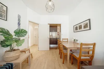a dining room with a table and chairs and a plant at Alegria Flat City Center with Elevator by Vacationy in Porto