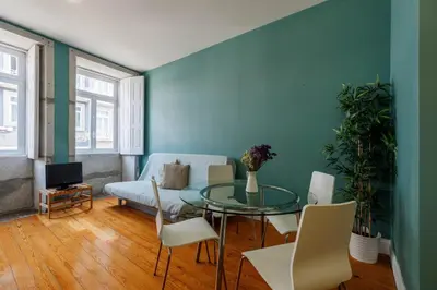 a living room with a glass table and a couch at CLUBE Charming Apartments - São Bento in Porto