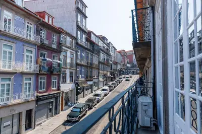 a city street with cars parked on the side of a building at CLUBE Charming Apartments - São Bento in Porto