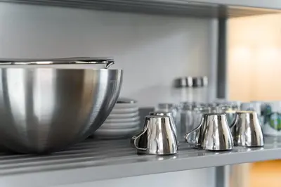 a kitchen counter with a bunch of silver pots and pans at GuestReady - Modern Duplex, Neo-Classical Building in Porto