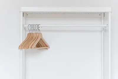 a closet with a wooden rack on a door at GuestReady - Modern Duplex, Neo-Classical Building in Porto