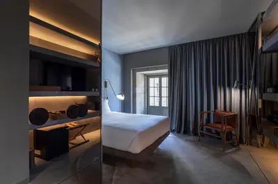 a hotel room with a bed and a desk at ICON Duplo Ribeira in Porto