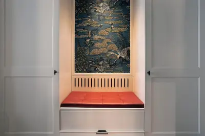 a bench in a room with a painting on the wall at ICON Duplo Ribeira in Porto