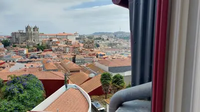 a view of a city from a window at Downtown Clerigos Duplex With River View by Vacationy in Porto