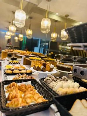 a buffet with many different types of pastries on display at TURIM Oporto Hotel in Porto