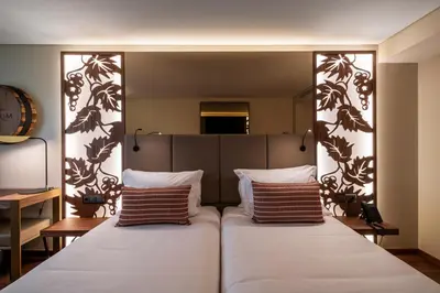 a bedroom with a large bed with two pillows at TURIM Oporto Hotel in Porto