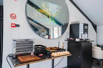 a kitchen with a mirror and a table with food at Smartr Porto Gaia & Spa in Vila Nova de Gaia