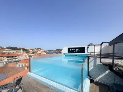 a swimming pool on the roof of a building at Smartr Porto Gaia & Spa in Vila Nova de Gaia