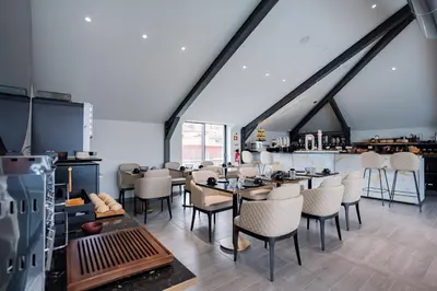 a restaurant with tables and chairs in a room at Smartr Porto Gaia & Spa in Vila Nova de Gaia