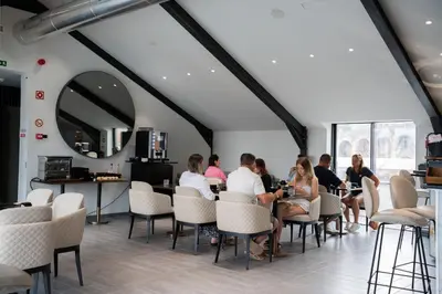 a group of people sitting at a table in a restaurant at Smartr Porto Gaia & Spa in Vila Nova de Gaia
