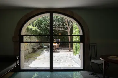 an arched window with a view of a garden at Almadina Smart Luxury in Porto