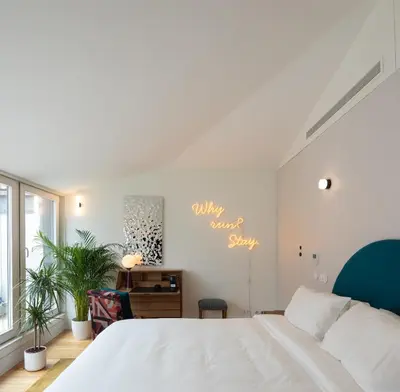 a bedroom with a white bed and a desk at Almadina Smart Luxury in Porto