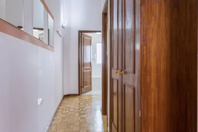 an empty hallway with a wooden door and a floor at Casa do Mirante in Porto