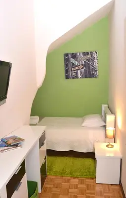 a green bedroom with a bed and a desk at Casa do Mirante in Porto