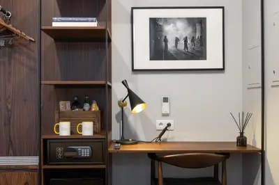 a home office with a desk and a picture on the wall at Utopian - Design Suites Porto - Free Minibar in Porto