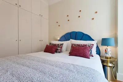 a bedroom with a bed with a blue headboard and red pillows at BOUTIQUE Rentals- DOURO Ribeira historical center with parking in Porto