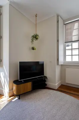 a living room with a flat screen tv on a wall at BOUTIQUE Rentals- DOURO Ribeira historical center with parking in Porto