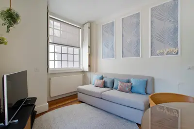 a living room with a couch and a tv at BOUTIQUE Rentals- DOURO Ribeira historical center with parking in Porto