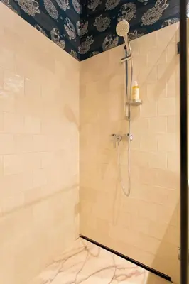 a bathroom with a shower with a shower head at BOUTIQUE Rentals-Isabella Ribeira Apt great views in Porto