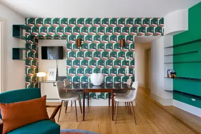 a dining room with a green wall with a table and chairs at BOUTIQUE Rentals-Isabella Ribeira Apt great views in Porto