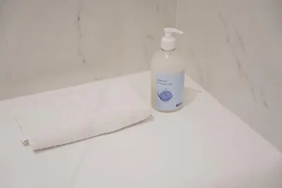 a bottle of detergent sitting next to a towel at GuestReady - Amazing stay near Cedofeita Church in Porto