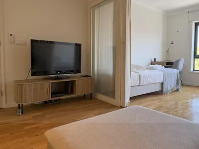 a living room with a flat screen tv on a entertainment center at Atayde da Câmara - Porto in Porto