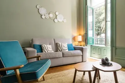 a living room with a couch and a table at Oporto family apartment in Porto