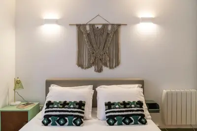 a bedroom with a bed with two pillows on it at Oporto family apartment in Porto