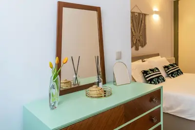 a bedroom with a dressing table and a mirror at Oporto family apartment in Porto