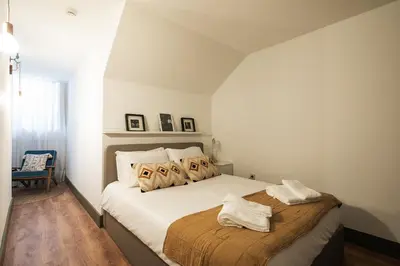a bedroom with a bed with two towels on it at Oporto family apartment in Porto