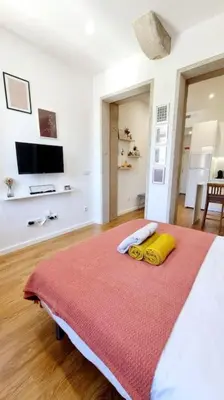 a bedroom with a bed with two towels on it at Glamour Dreaming Studio in Porto