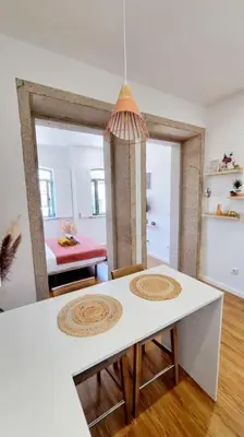 a kitchen with a white table and a dining room at Glamour Dreaming Studio in Porto