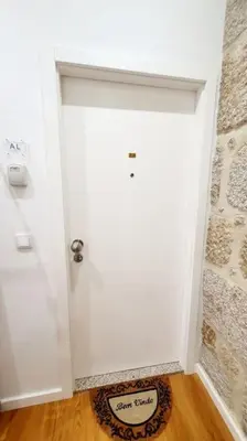 a white door in a room with a wooden floor at Glamour Dreaming Studio in Porto