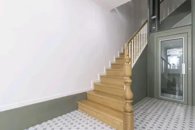a staircase in a home with a wooden stair case at Glamour Dreaming Studio in Porto