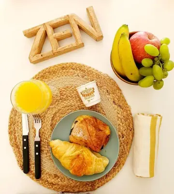 a table with a plate of food and fruit at Glamour Dreaming Studio in Porto