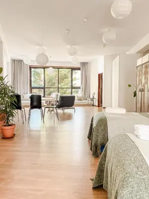 a bedroom with two beds and a table and chairs at Central Loft with free parking in Porto