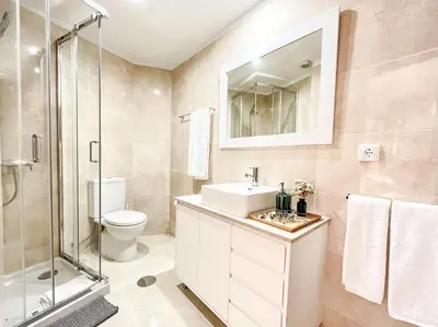 a bathroom with a toilet sink and a shower at Central Loft with free parking in Porto