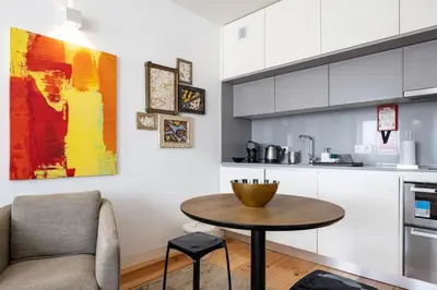 a kitchen with a table and a chair in a kitchen at S. Lázaro Studio in Porto