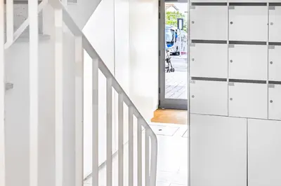 a white staircase leading up to a door at S. Lázaro Studio in Porto
