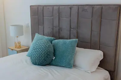 a group of pillows sitting on top of a bed at Stunning Apartment w/ Free Parking by LovelyStay in Porto